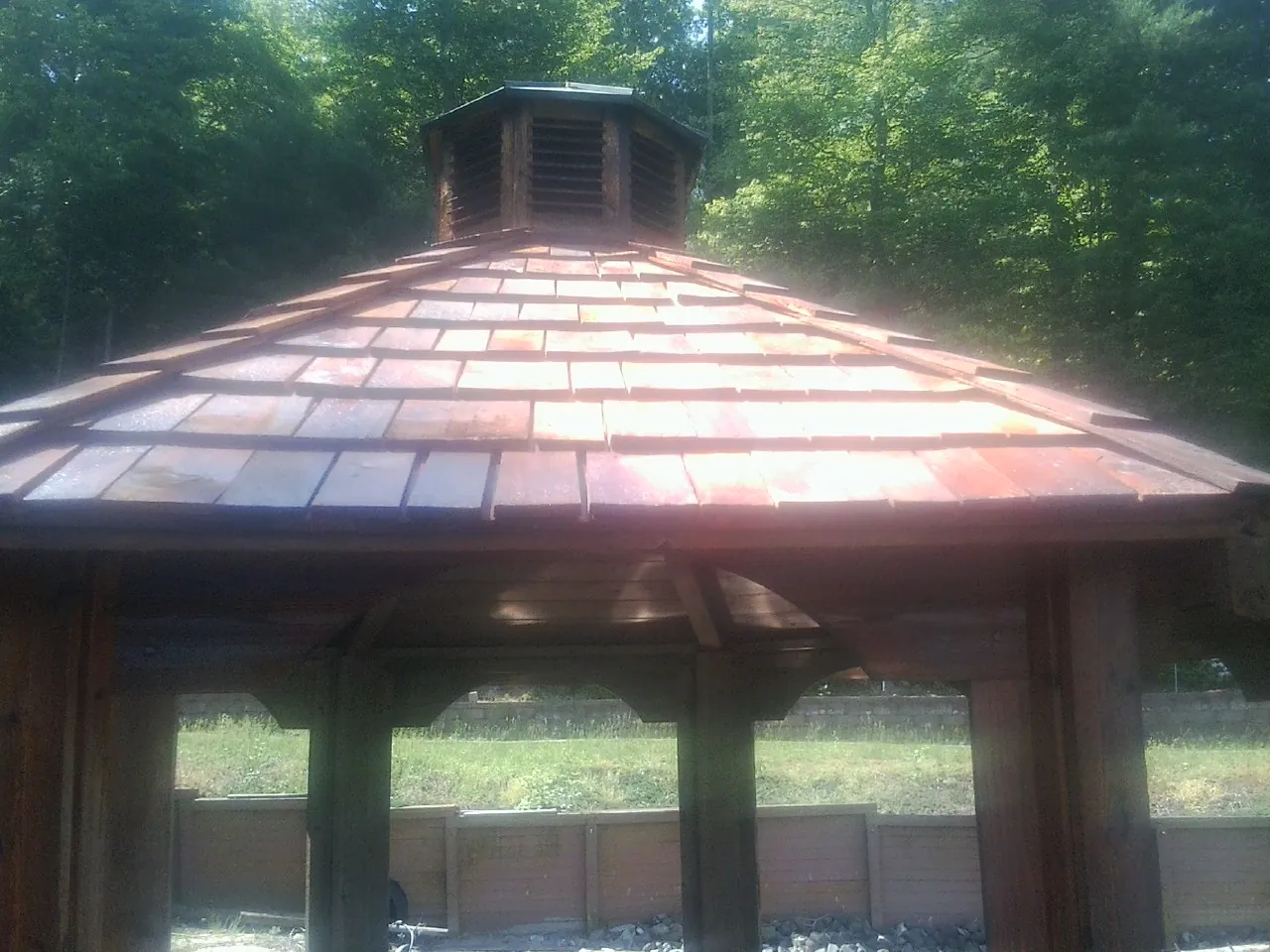 New cedar shake roof and cupola on a lakeside gazebo in Pipestone